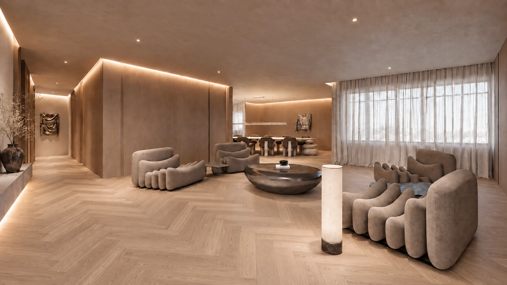 Warm taupe living space with sculptural curved armchairs, a dark round coffee table, cove lighting and sheer curtains