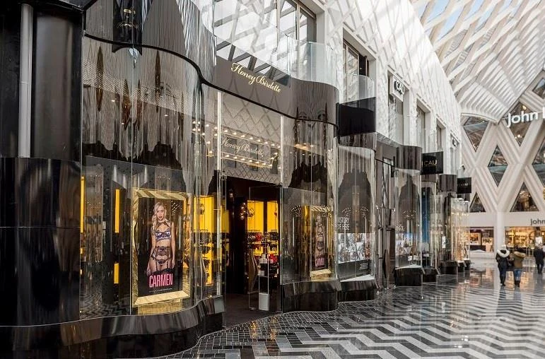 Honey Birdette boutique with a curved black and gold shopfront in a shopping centre